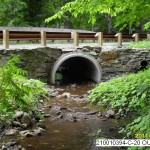 a well designed culvert allowing a stream to pass under a road