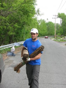 Photo of Elia carting trash to trash pile.