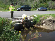 surveyors measuring a small culvert