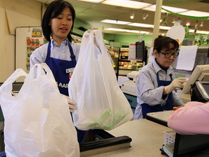 A cashier bags groceries last week in San Francisco.