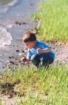 Description: Child playing with                                             water