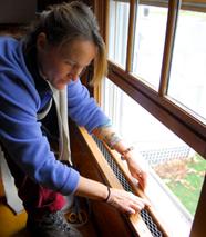 CET                             instructor Beth Paulson weatherstrips a                             window in Williamstown, MA.