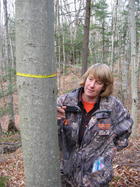 Susan Morse showing bear claw mark on beech tree