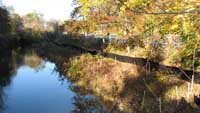 river with silt fence running along the bank