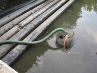 pump in river next to pipes